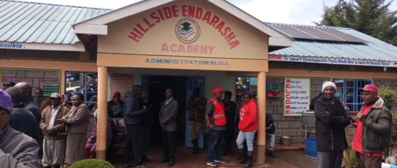 Parents outside the administration block at Endarasha Academy.